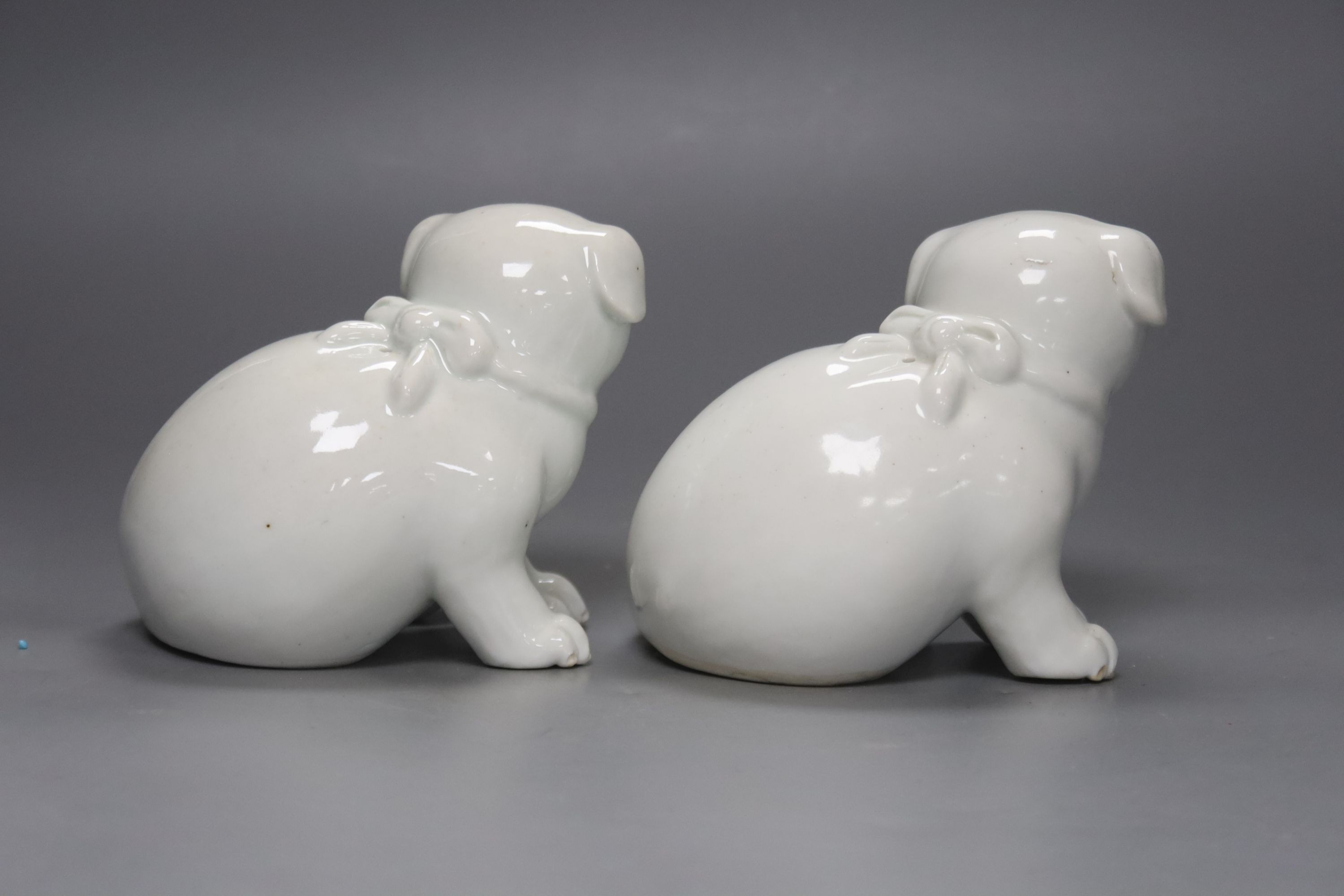 Two Japanese Hirado models of seated puppies, 19th century, 11cm tall